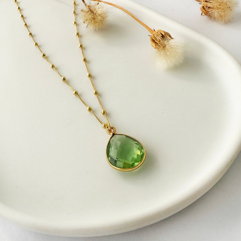 Raw Peridot Necklace in a Satellite chain. 
You will love the bright green color of the peridot pendant.
925 Sterling Silver, 24K Gold finish.
Peridot necklace is great for wearing alone or as a stacking necklace.
Peridot  promotes peace and balance.