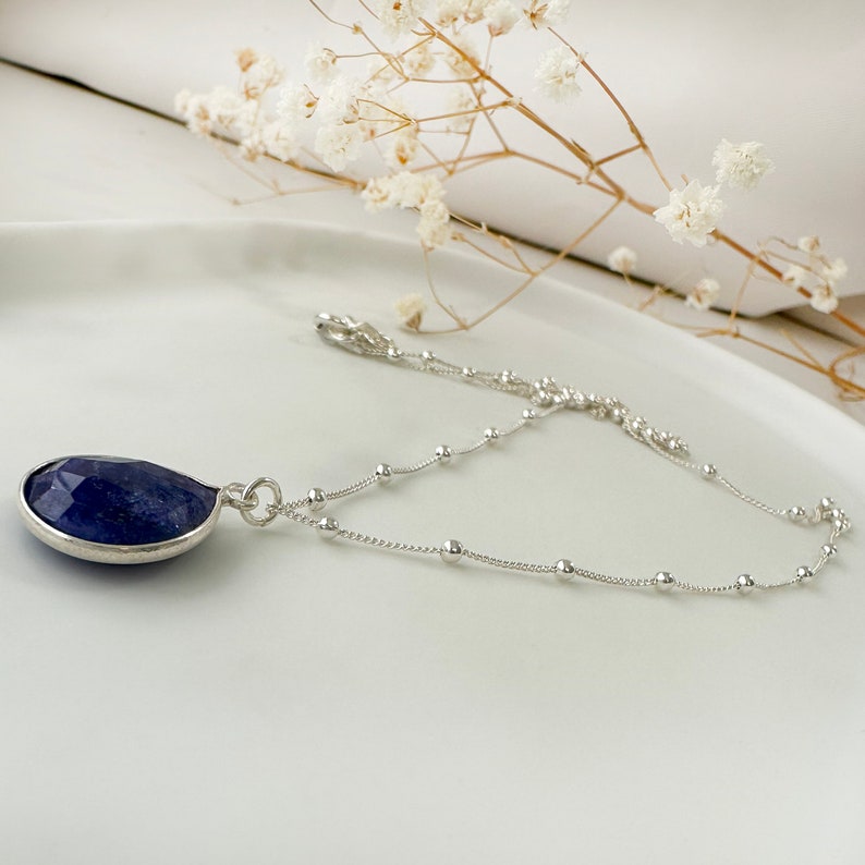 Genuine Raw Blue Sapphire Necklace 
A Good Vibes Necklace to offer as a September Birthstone Necklace.

A Real Blue Sapphire Teardrop pendant in a satellite chain necklace.

 High-Quality Solid 925 Sterling Silver

 Sterling Silver ∙ 24K Gold