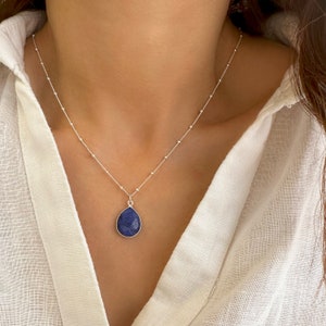 Genuine Raw Blue Sapphire Necklace 
A Good Vibes Necklace to offer as a September Birthstone Necklace.

A Real Blue Sapphire Teardrop pendant in a satellite chain necklace.

 High-Quality Solid 925 Sterling Silver

 Sterling Silver ∙ 24K Gold