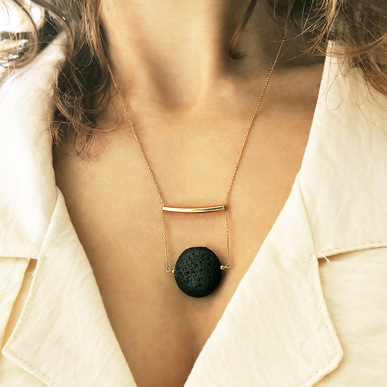 This real lava necklace is great Aromatherapy jewelry!

At the same time this 	Lava stone pendant, is a unique fidget necklace.
 
You will love this LAVA rock Diffuser Necklace.

Natural lava stone 
925 sterling silver that is yellow gold filled