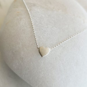 Minimalist heart Necklace with an extra tiny heart pendant
Sterling Silver 925   
The small heart necklace adds a sparkling shine to your style.
With a matt but shiny finish that makes is so unique!

Ideal for a birthday or Bridesmaid Gift