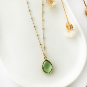 Raw Peridot Necklace in a Satellite chain. 
You will love the bright green color of the peridot pendant.
925 Sterling Silver, 24K Gold finish.
Peridot necklace is great for wearing alone or as a stacking necklace.
Peridot  promotes peace and balance.