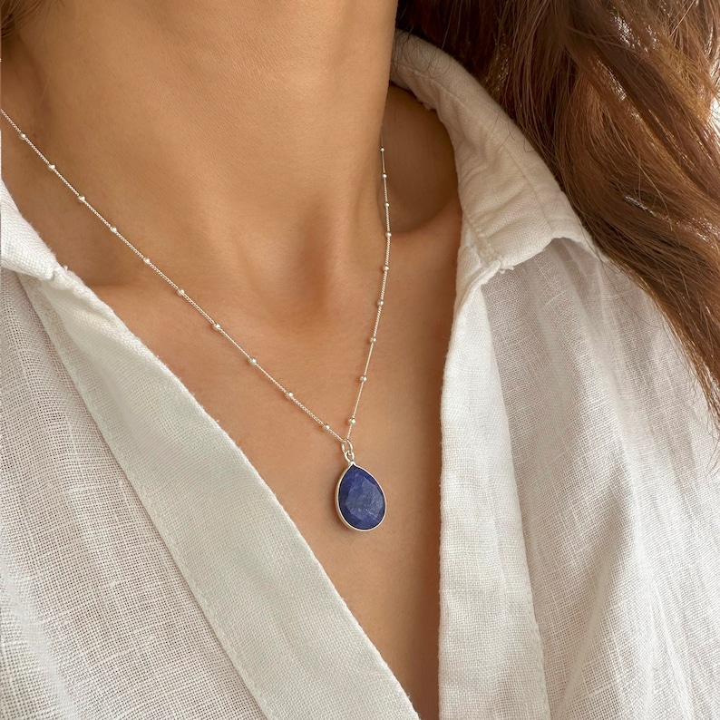 Genuine Raw Blue Sapphire Necklace 
A Good Vibes Necklace to offer as a September Birthstone Necklace.

A Real Blue Sapphire Teardrop pendant in a satellite chain necklace.

 High-Quality Solid 925 Sterling Silver

 Sterling Silver ∙ 24K Gold