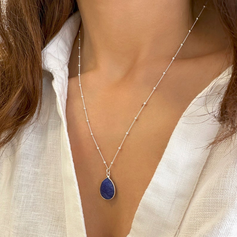 Genuine Raw Blue Sapphire Necklace 
A Good Vibes Necklace to offer as a September Birthstone Necklace.

A Real Blue Sapphire Teardrop pendant in a satellite chain necklace.

 High-Quality Solid 925 Sterling Silver

 Sterling Silver ∙ 24K Gold