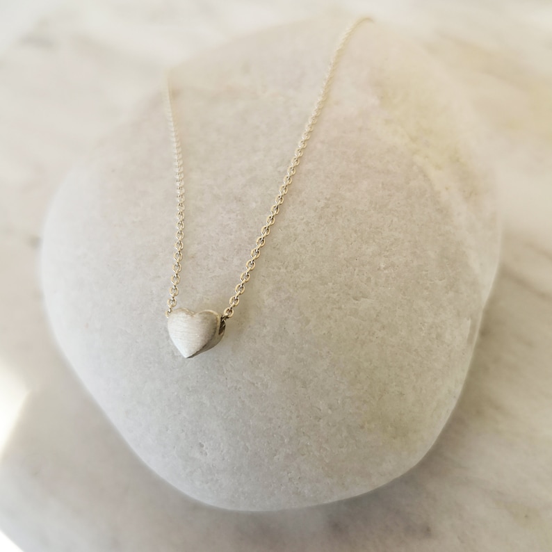 Minimalist heart Necklace with an extra tiny heart pendant
Sterling Silver 925   
The small heart necklace adds a sparkling shine to your style.
With a matt but shiny finish that makes is so unique!

Ideal for a birthday or Bridesmaid Gift