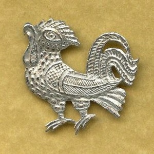 May include: A silver-colored rooster charm with a detailed design. The rooster is standing with its head turned to the side and its tail feathers spread out.