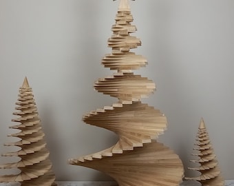 May include: Three wooden Christmas trees of varying sizes. The largest tree has a spiral design and a star on top. The other two trees have a more traditional conical shape. All trees are made of light-colored wood.