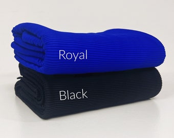 May include: Two rolls of ribbed fabric, one royal blue and one black. The fabric is folded and stacked on top of each other. The words "Royal" and "Black" are printed on the fabric.