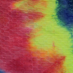 May include: A close-up of a tie-dye fabric with a textured, quilted pattern. The fabric is a mix of red, orange, yellow, green, and blue.