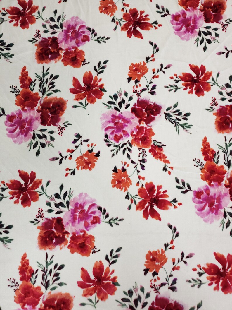May include: White fabric with a repeating pattern of pink, red, and orange watercolour flowers. The flowers are stylised and have a painterly look.