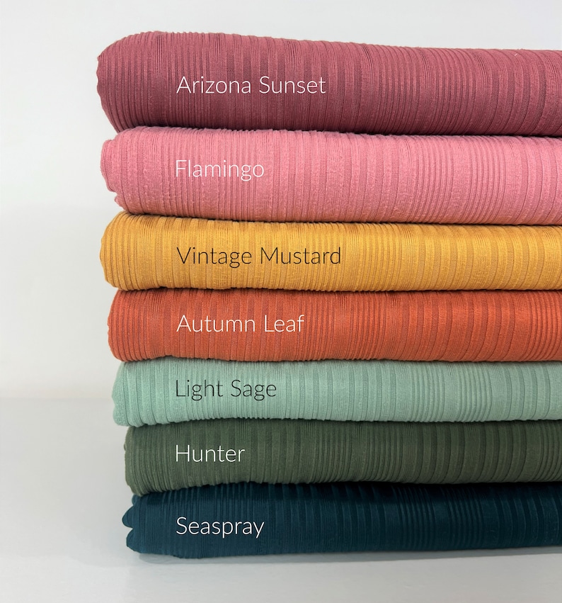 May include: A stack of seven fabric swatches in various colours, including Arizona Sunset, Flamingo, Vintage Mustard, Autumn Leaf, Light Sage, Hunter, and Seaspray.