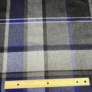 May include: Blue, gray, and white plaid fabric with a ruler measuring 12 inches.