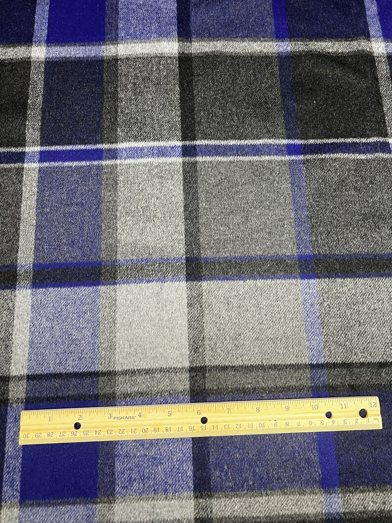 May include: Blue, gray, and white plaid fabric with a ruler measuring 12 inches.