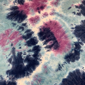 May include: Abstract tie-dye fabric with a swirling pattern of blue, white, and pink.