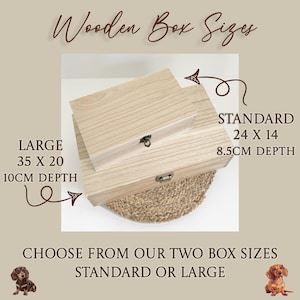May include: Two rectangular light-colored wooden boxes with metal latches. Text reads: Wooden Box Sizes, STANDARD 24 X 14 8.5CM DEPTH, LARGE 35 X 20 10CM DEPTH, CHOOSE FROM OUR TWO BOX SIZES STANDARD OR LARGE. Two small dachshund illustrations are included.