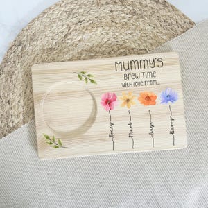May include: Wooden serving tray with a cutout for a mug, featuring the text "Mommy's Brew Time with love from..." and four painted flowers with names below them: "Tracy", "Mark", "Sage", and "Barry".