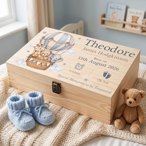 May include: A rectangular wooden keepsake box featuring a printed illustration of a hot air balloon with a giraffe, bear, and elephant. Text includes the name Theodore James Hodgkinson, birth date 15th August 2026, 9:04am, and 7lb 3oz.