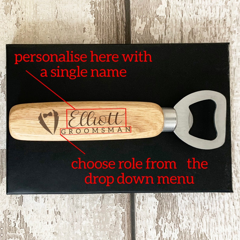May include: A wooden bottle opener with a silver metal opener. The handle is engraved with the text "Elliott GROOMSMAN".