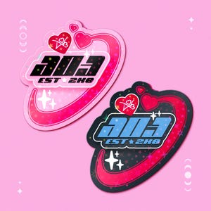 May include: Two stickers with a pink background. One sticker is pink with a red heart and the text "303 EST 2H8". The other sticker is black with a red heart and the text "303 EST 2H8". Both stickers have a star and heart design.
