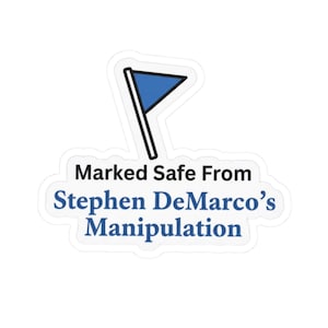 May include: A white sticker with a blue flag graphic and the text "Marked Safe From Stephen DeMarco's Manipulation" in black and blue. The flag is a blue triangle on a black pole.