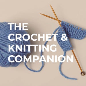 May include: A blue yarn ball, knitting needles, and a knitted swatch are featured in this image. The text "THE CROCHET & KNITTING COMPANION" is displayed in white. The image has a neutral background, and the yarn is a soft, light blue color.