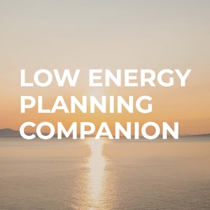 May include: Image features the text "LOW ENERGY PLANNING COMPANION" in white, set against a serene backdrop of a sunset over the ocean. The sky transitions from warm orange to a soft yellow, with the sun's reflection on the water.