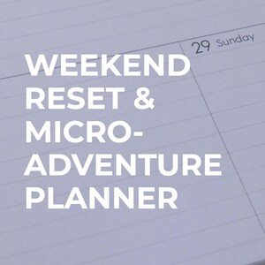 May include: A close-up of a planner with the text "WEEKEND RESET & MICRO-ADVENTURE PLANNER" in white. The planner is open to a page with the date "29 Sunday" at the top. The pages have horizontal lines.