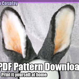 May include: A pair of gray bunny ears with white and orange fur. The ears are on a white background with the text "PDF Pattern Download" and "Print it yourself at home".