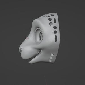 May include: A light gray, 3D-rendered mask in the shape of a stylized animal head, possibly a feline or canine. The mask has large eye sockets, a snout, and a smiling mouth. The side of the mask features several circular and oval cutouts.