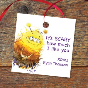 May include: A white gift tag with a yellow monster illustration and purple text that reads "It's SCARY how much I like you XOXO, Ryan Thomson".