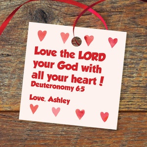 May include: White card with red hearts and the text "Love the LORD your God with all your heart! Deuteronomy 6:5 Love, Ashley"