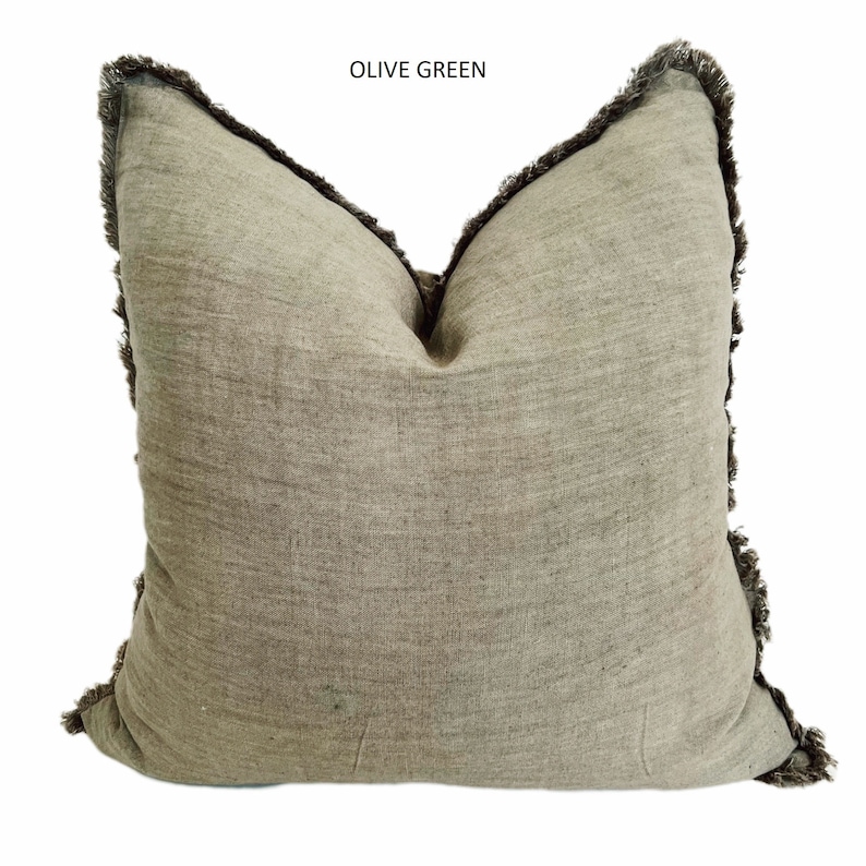 May include: Olive green throw pillow with a fringed edge.
