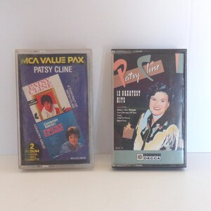 May include: Two vintage Patsy Cline cassette tapes. One features a portrait of Patsy Cline and the text "MCA Value Pax." The other tape is labeled "12 Greatest Hits" with a portrait of Patsy Cline.