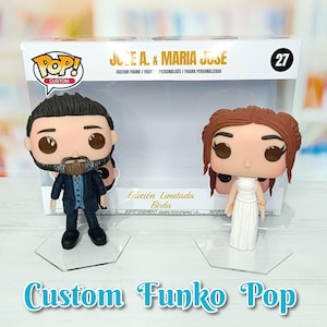 May include: Custom Funko Pop figures of a bride and groom. The bride is wearing a white dress and the groom is wearing a blue suit. The figures are on clear plastic stands. The box says "Edici&oacute;n Limitada Boda" which means "Limited Edition Wedding" in Spanish.