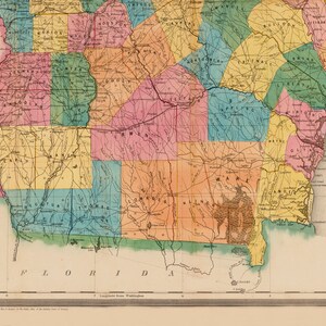 May include: A vintage map of the state of Georgia, showing the counties and their boundaries. The map is colour-coded, with each county represented by a different colour. The map also includes a key that identifies the counties by name and colour.