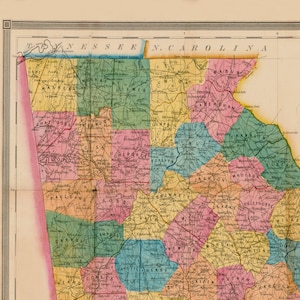 May include: A vintage map of the border between Tennessee and North Carolina, showing the counties of each state. The map is colour-coded by county and includes the names of each county. The map is printed on cream-coloured paper with a brown border.