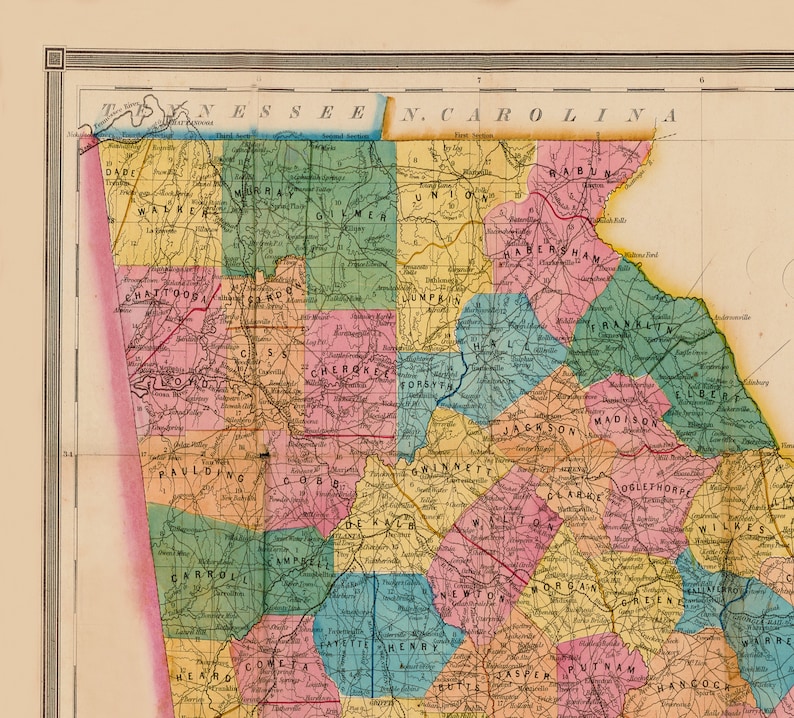 May include: A vintage map of the border between Tennessee and North Carolina, showing the counties of each state. The map is colour-coded by county and includes the names of each county. The map is printed on cream-coloured paper with a brown border.