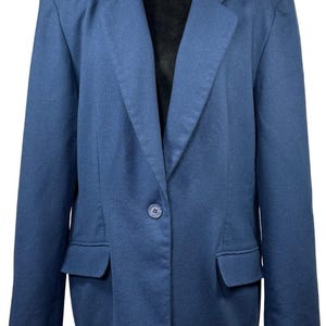 May include: A solid blue blazer featuring a single-button closure, notched lapels, and two front flap pockets. The garment has long sleeves, structured shoulders, and a straight hemline, presented against a plain white background.