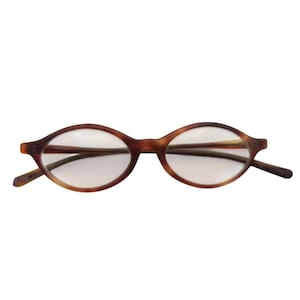 May include: Oval-shaped eyeglasses featuring a brown tortoiseshell pattern frame with clear lenses. The frames have a distinct pointed outer edge design and thin temples that extend from the sides of the front lens rims.