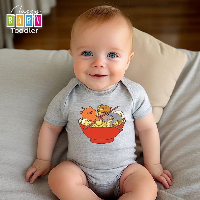 a baby sitting on a bed wearing a bodysuit