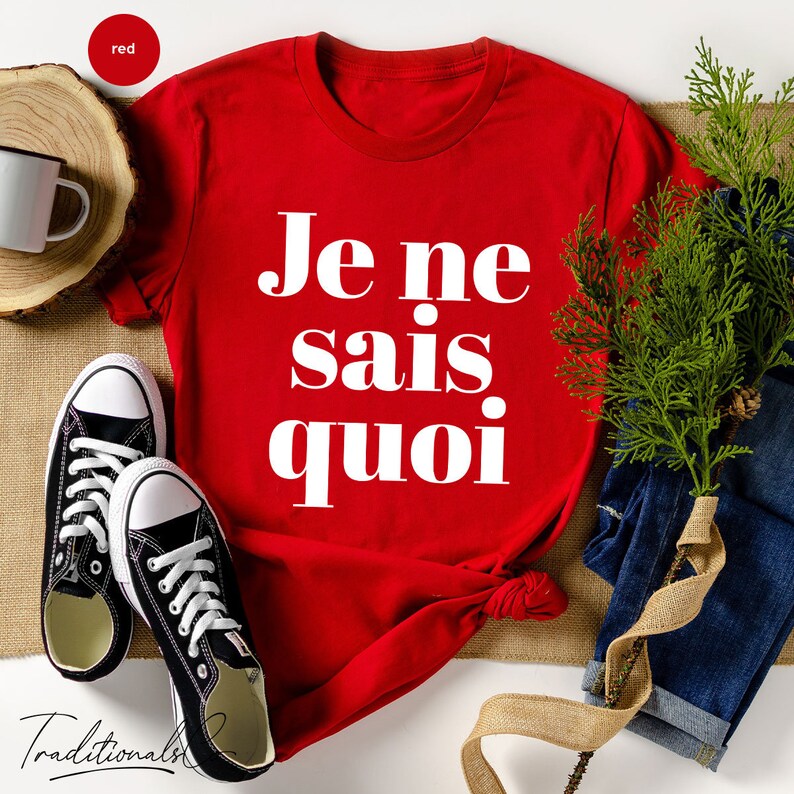 May include: Red t-shirt with white text that says "Je ne sais quoi".