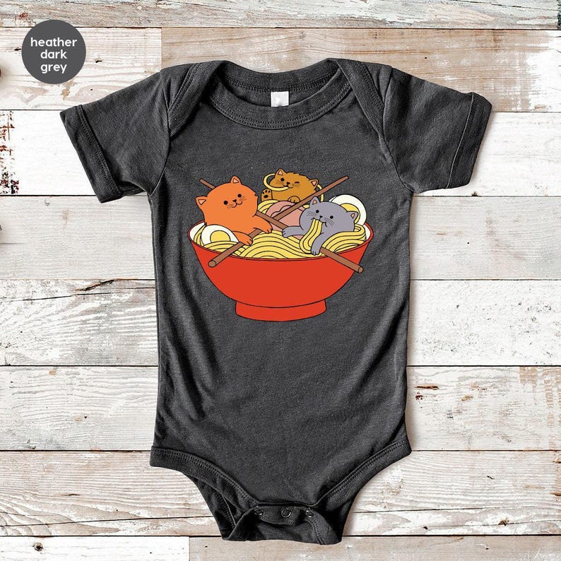 a baby bodysuit with a picture of two cats in a bowl of noodles