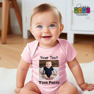 a baby wearing a pink shirt with a picture of a baby on it