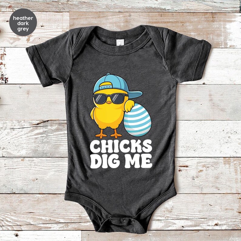 a baby bodysuit with a chicken wearing sunglasses and a hat