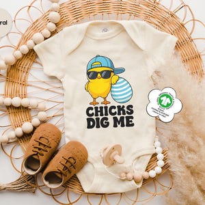 a baby bodysuit with a chick's dig me on it