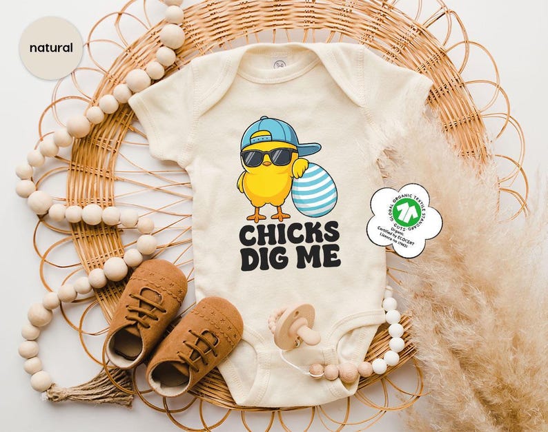 a baby bodysuit with a chick's dig me on it
