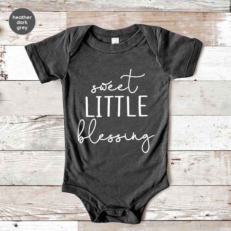 a black onesuit with the words sweet little blessing printed on it