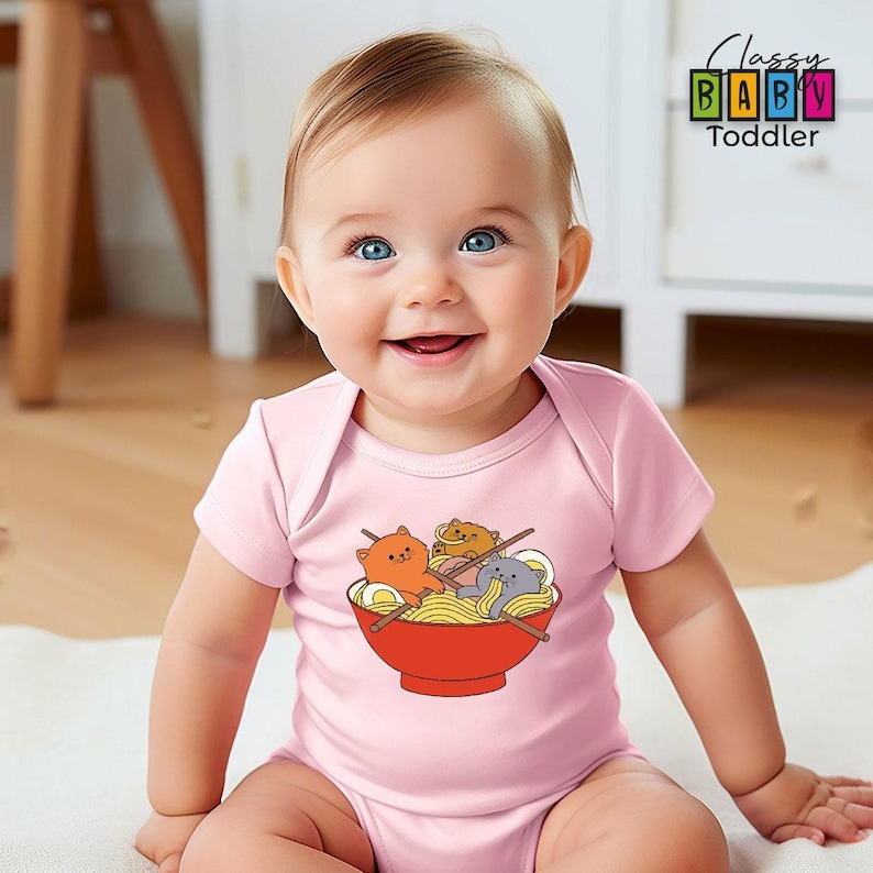 a baby sitting on the floor wearing a pink shirt