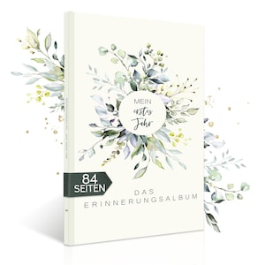 Könnte beinhalten: Ein weißes Buch mit einem grünen und blauen Blumendesign auf dem Cover. Das Buch trägt den Titel "Mein erstes Jahr" und den Text "Das Erinnerungsalbum" auf dem Cover. Das Buch hat 84 Seiten.