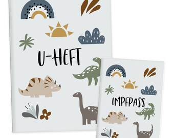 May include: Two blue and white folders with dinosaur and rainbow illustrations. The larger folder says "U-HEFT" and the smaller folder says "IMPFPASS".